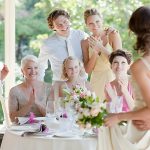 which mother is seated first at a wedding photo